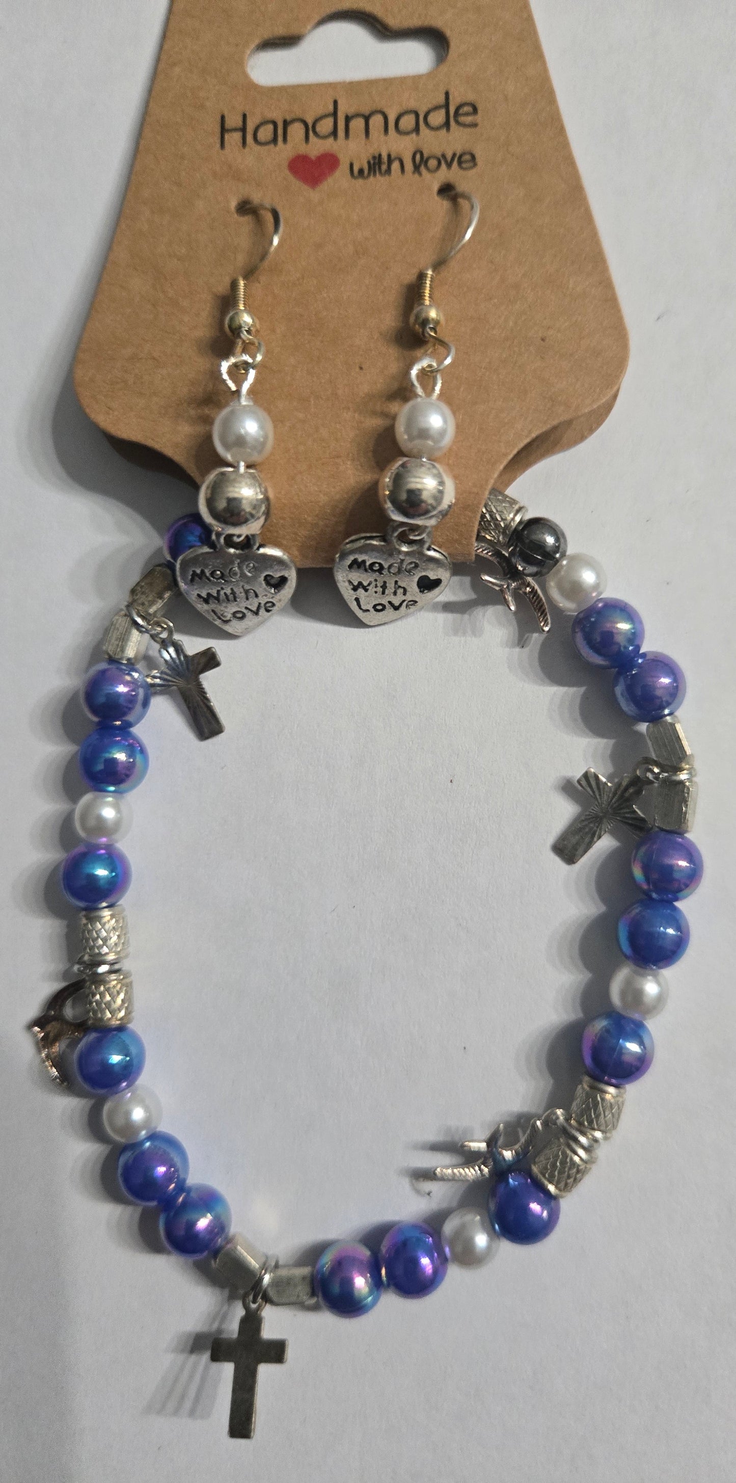 Bracelet with blue and white beads, accented with silver in color cross charms + "Made With Love" heart earrings.