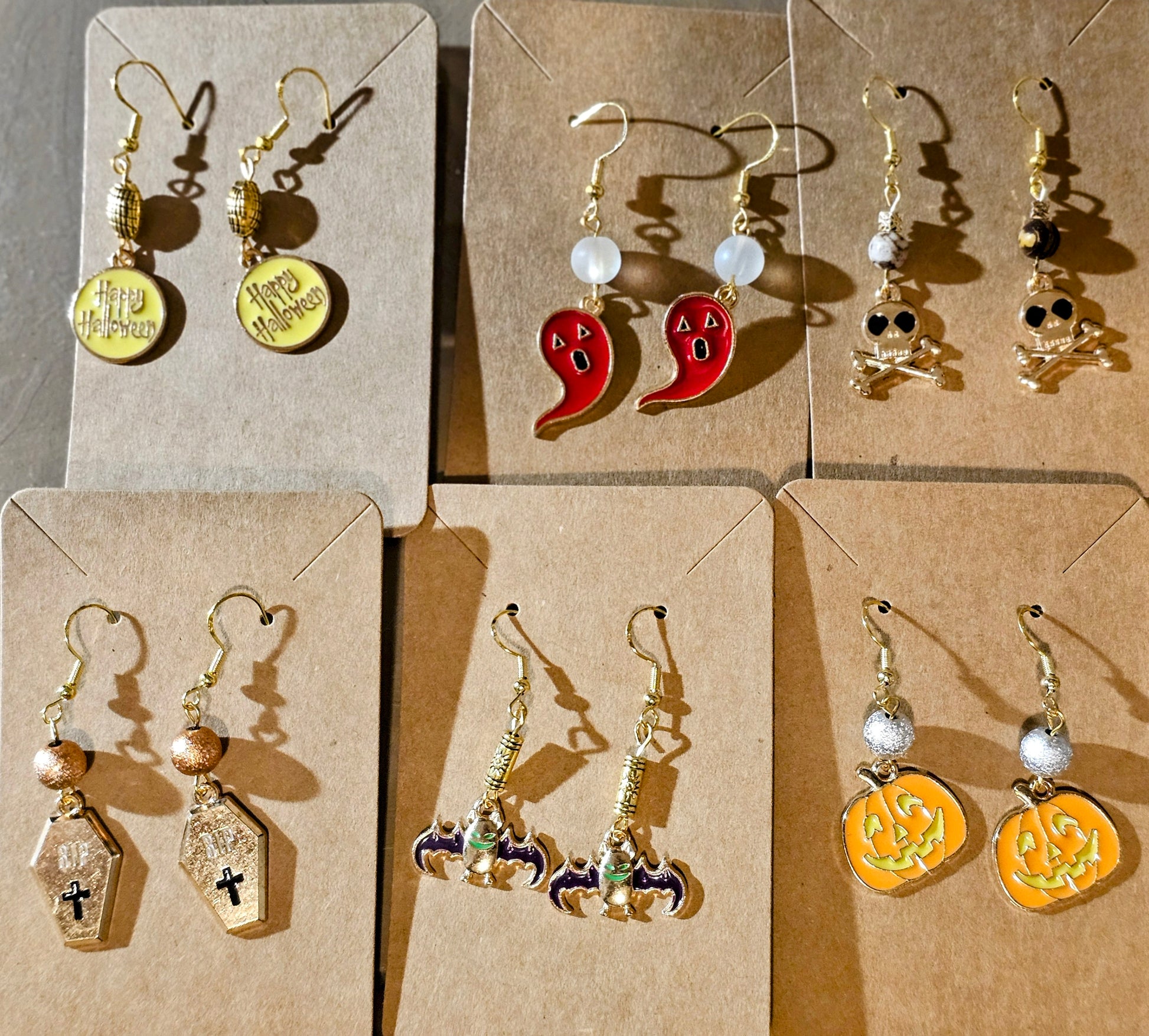 Halloween-themed earrings crafted on gold plated earring facets.