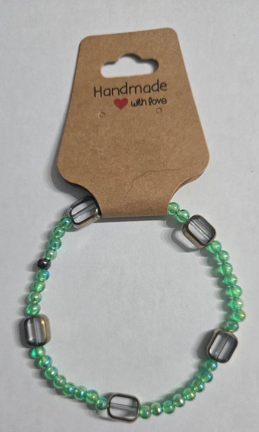 Green beaded bracelet with brass accents.