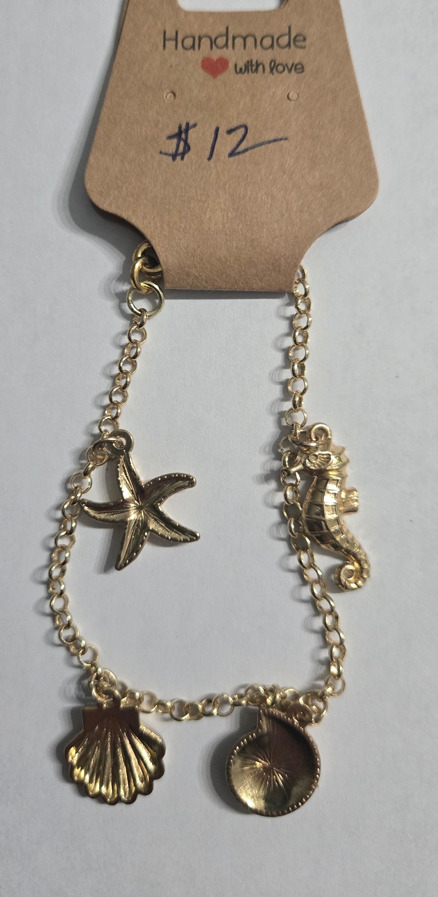 Gold in color chain bracelet with gold in color sea charms.