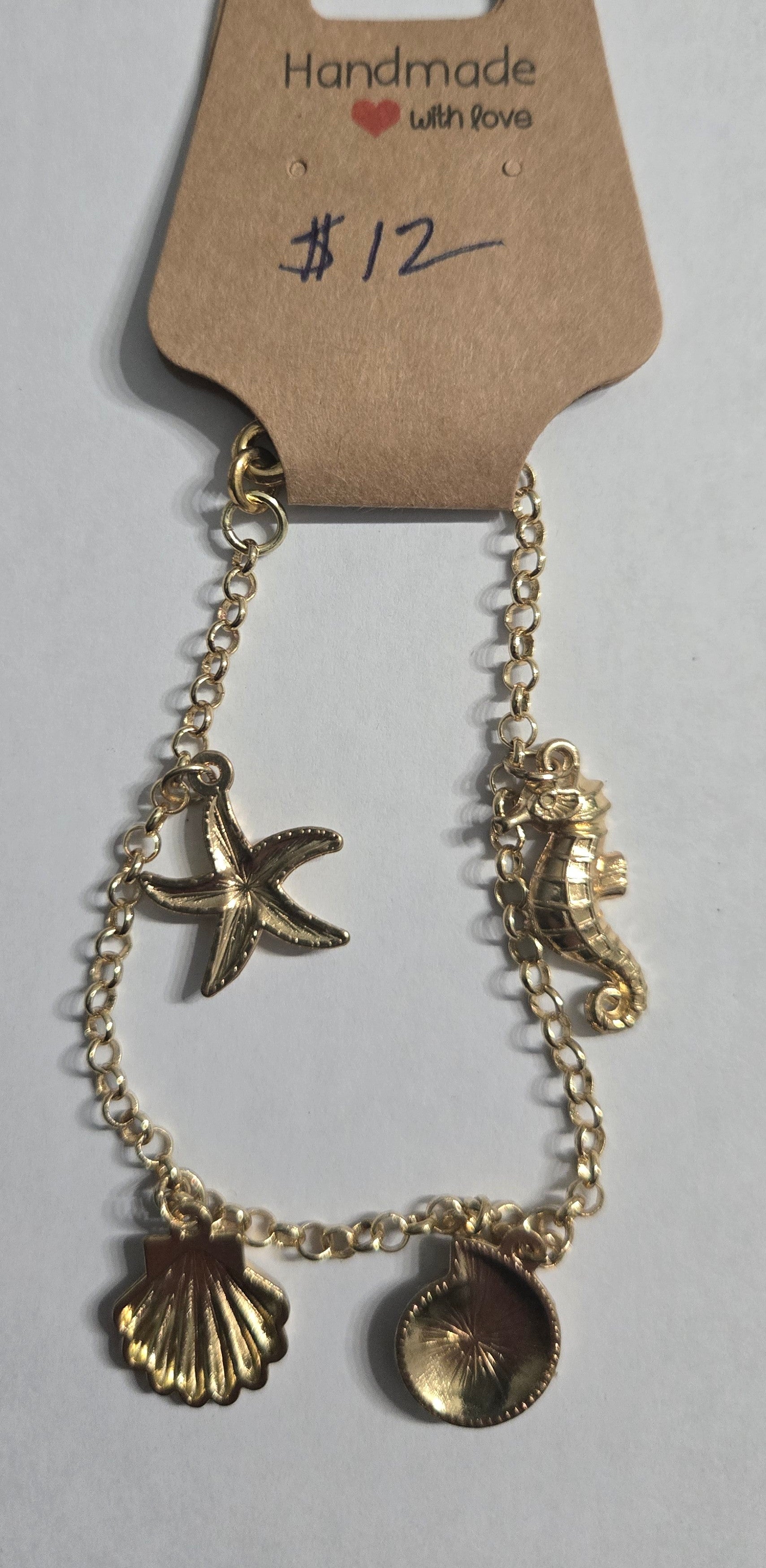 Gold in color chain bracelet with gold in color sea charms.