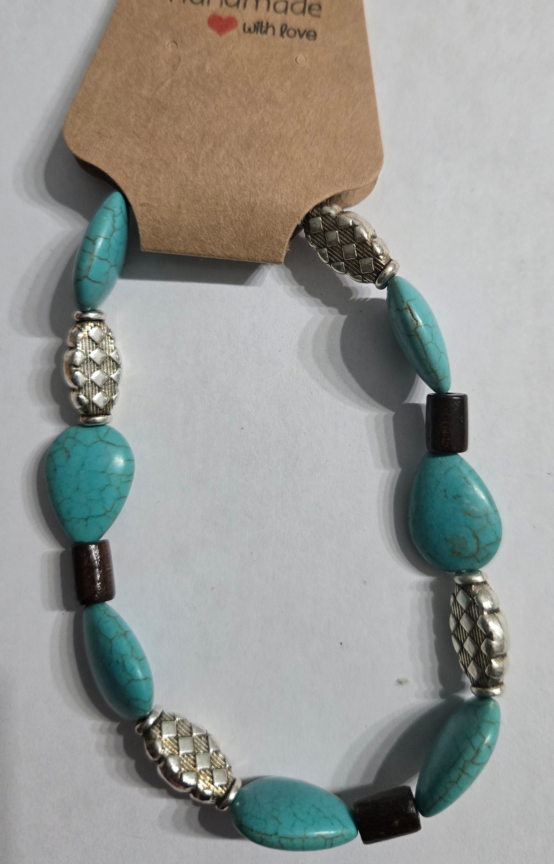 Turquoise beaded bracelet with silver and brown wooden accents.