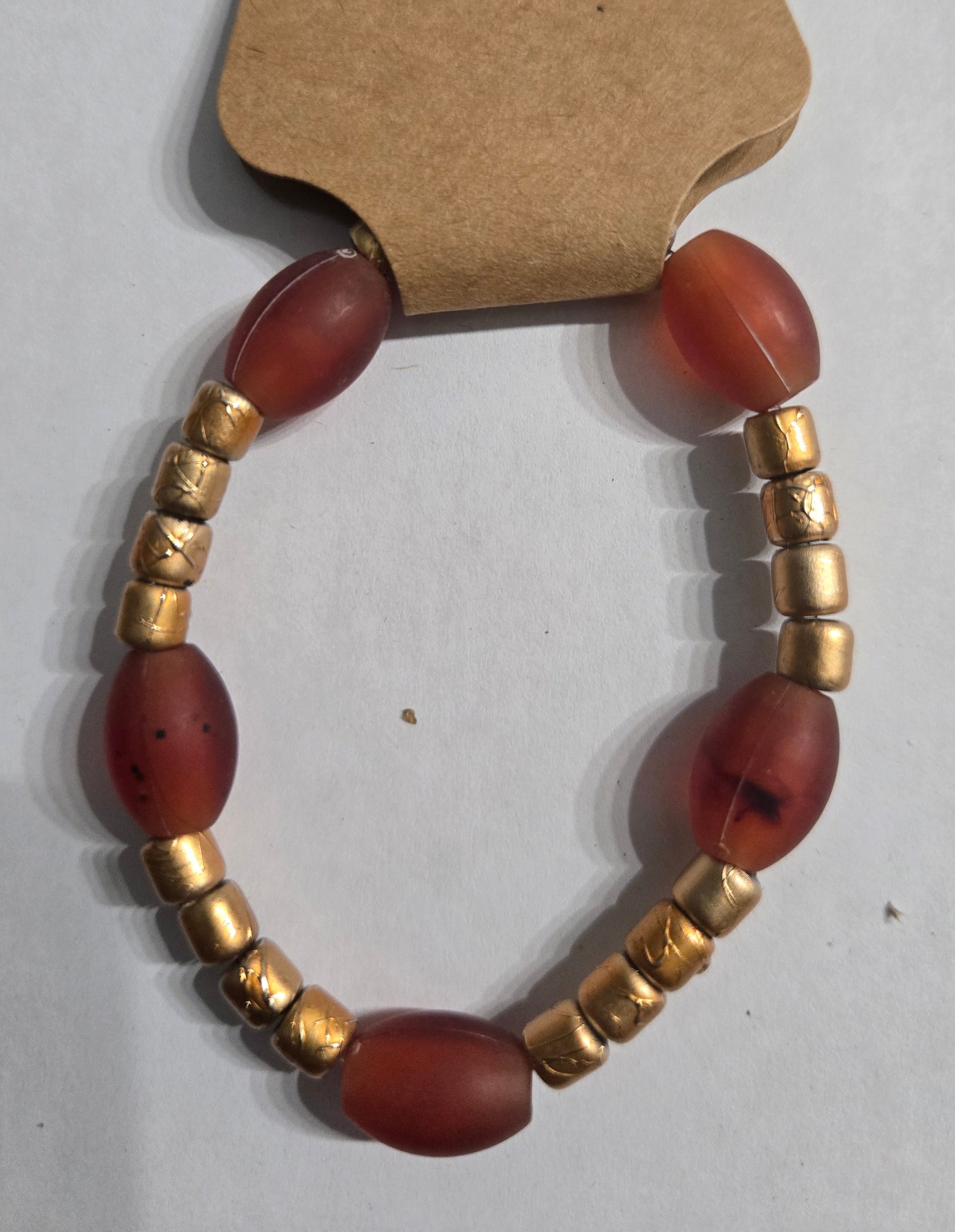 Bracelet with red beads and gold accents.