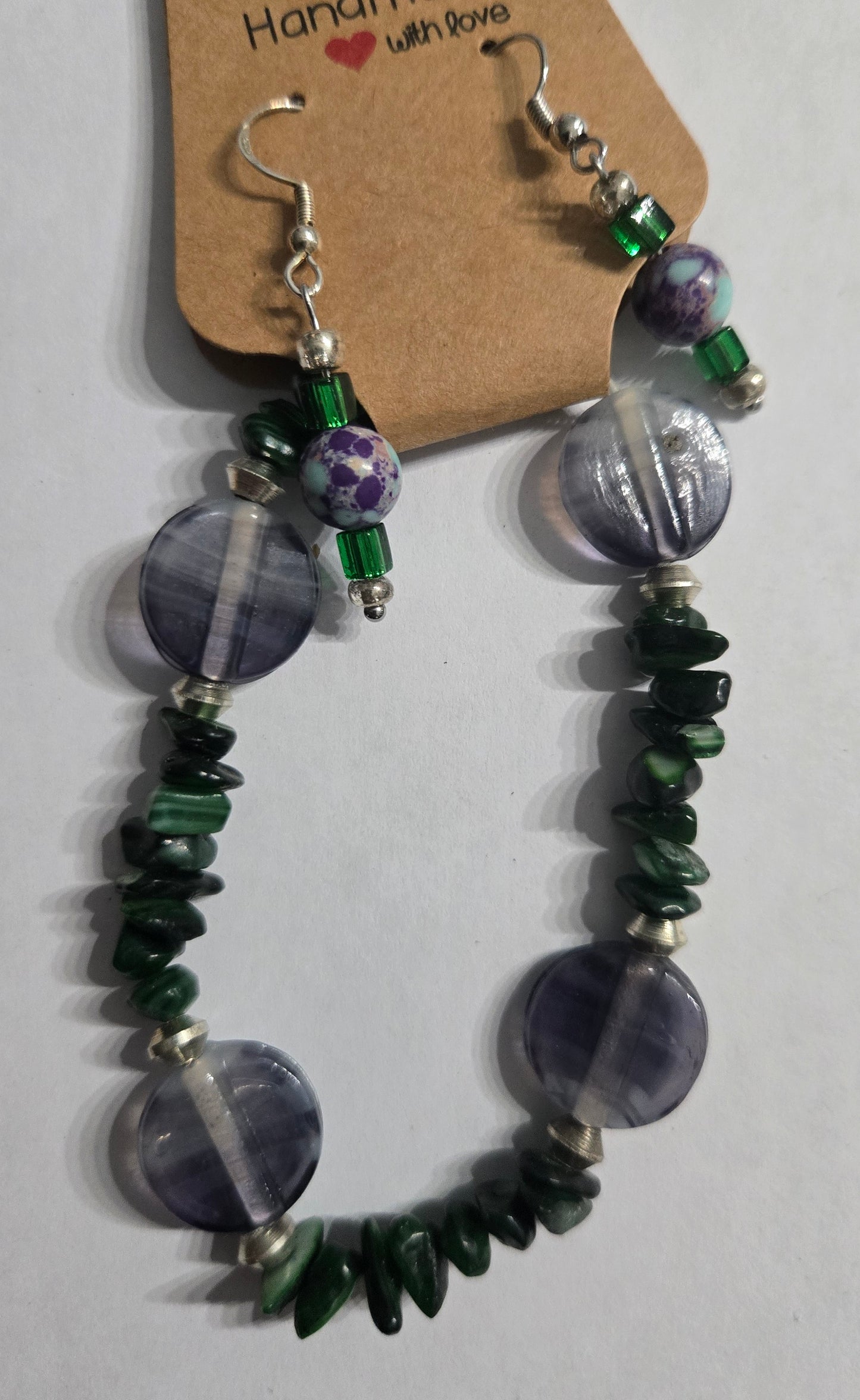 Bracelet crafted with green stones, and accented with purple disk spacer beads + matching earrings