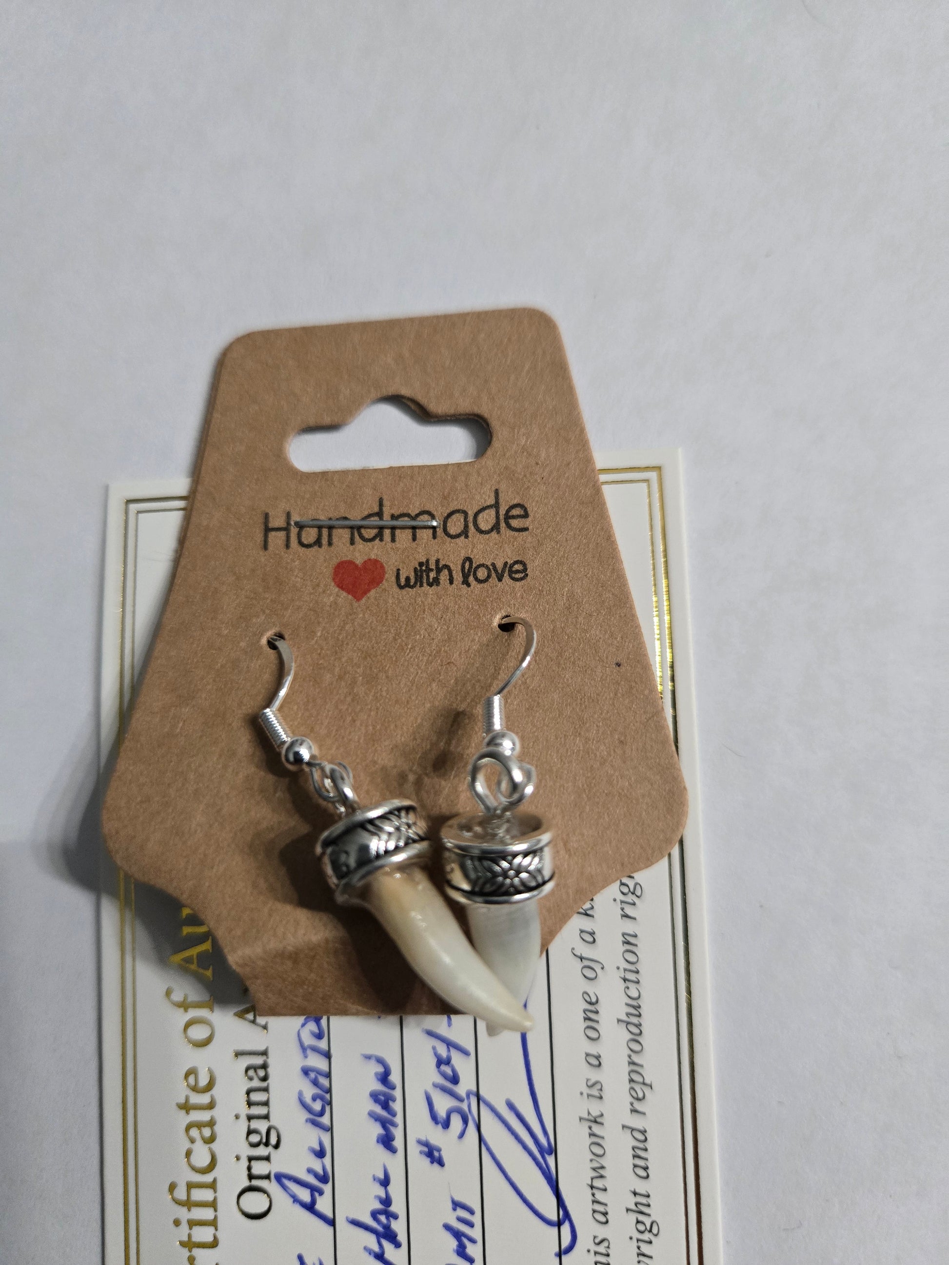 Genuine Alligator Teeth earrings on sterling silver earring facets.