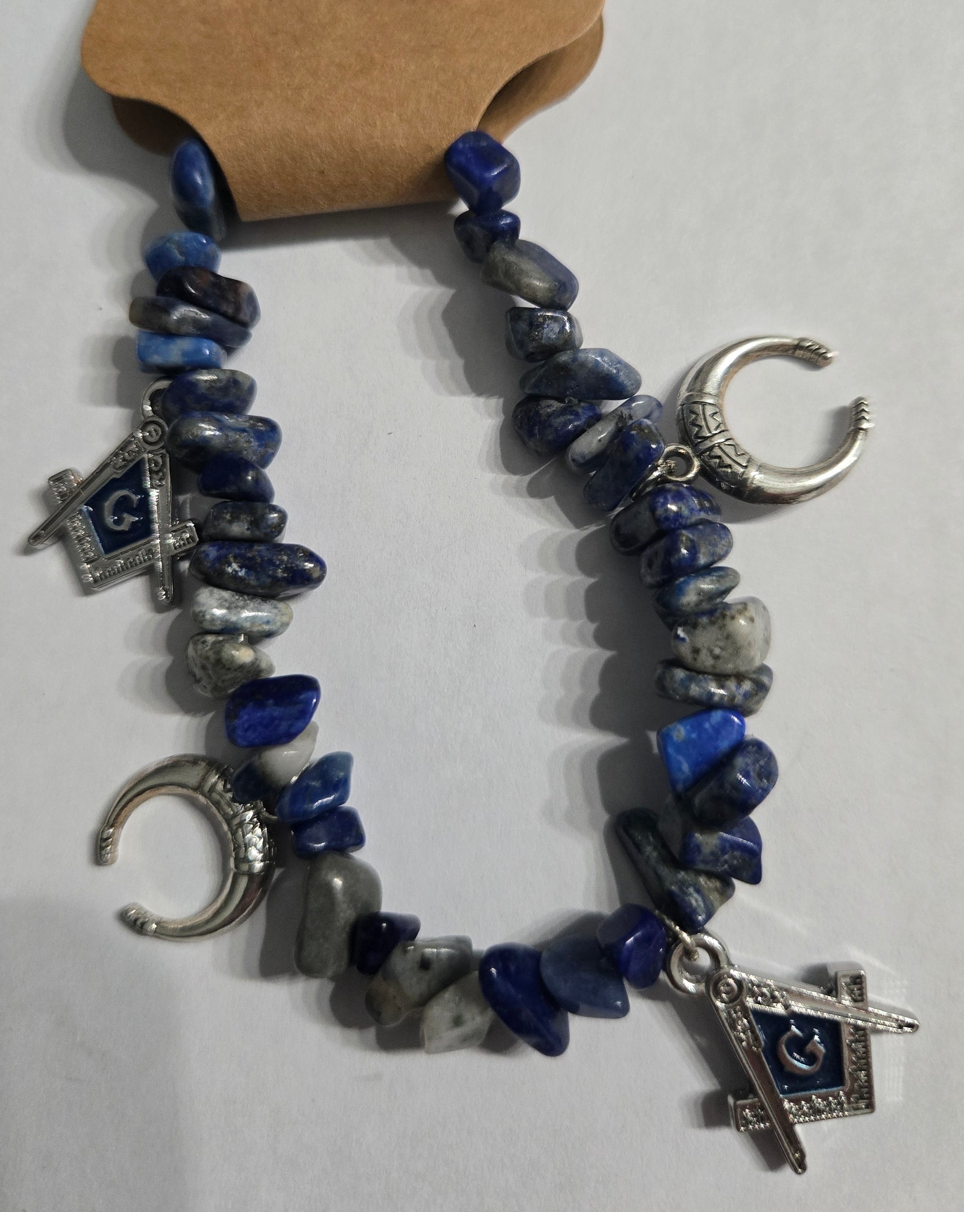 Genuine Lapis Lazuli gemstone bracelet, accented with silver in color Masonic and crescent moon charms.