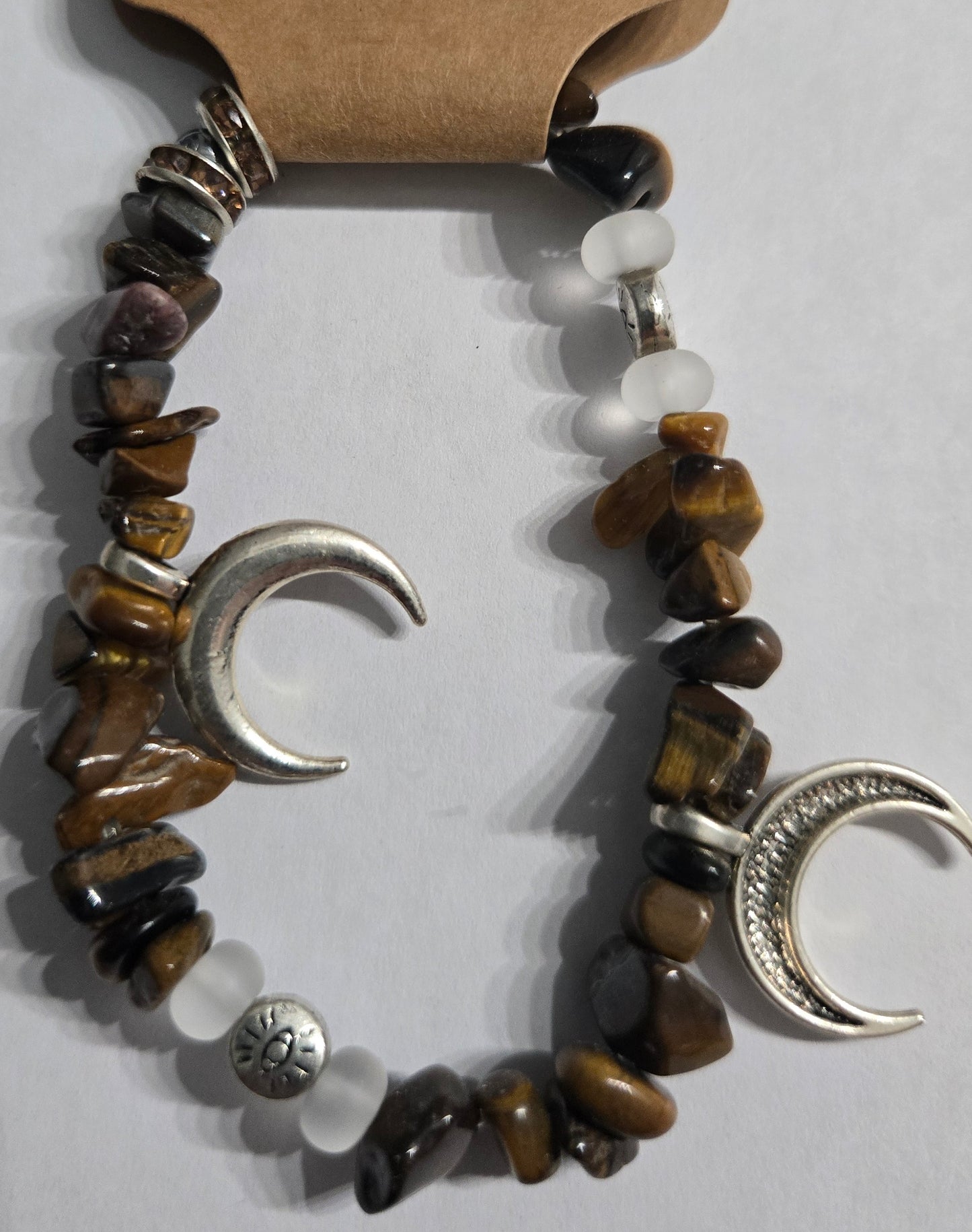 Genuine Tiger's Eye gemstone bracelet, accented with silver in color crescent moon and All Seeing Eye charms.