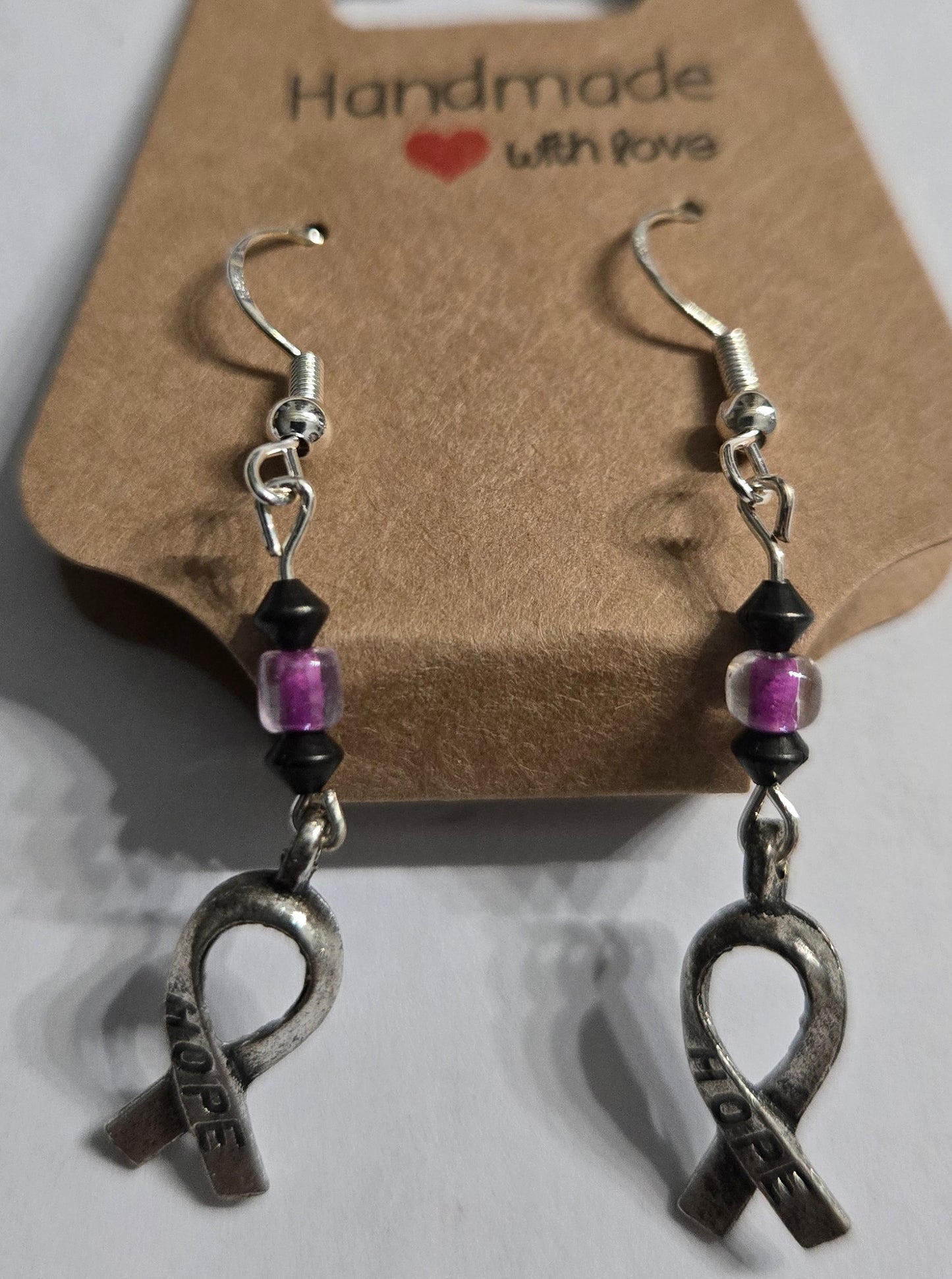 Sterling silver earrings with purple / black beads, accented with BCA "Hope" ribbon pendants.
