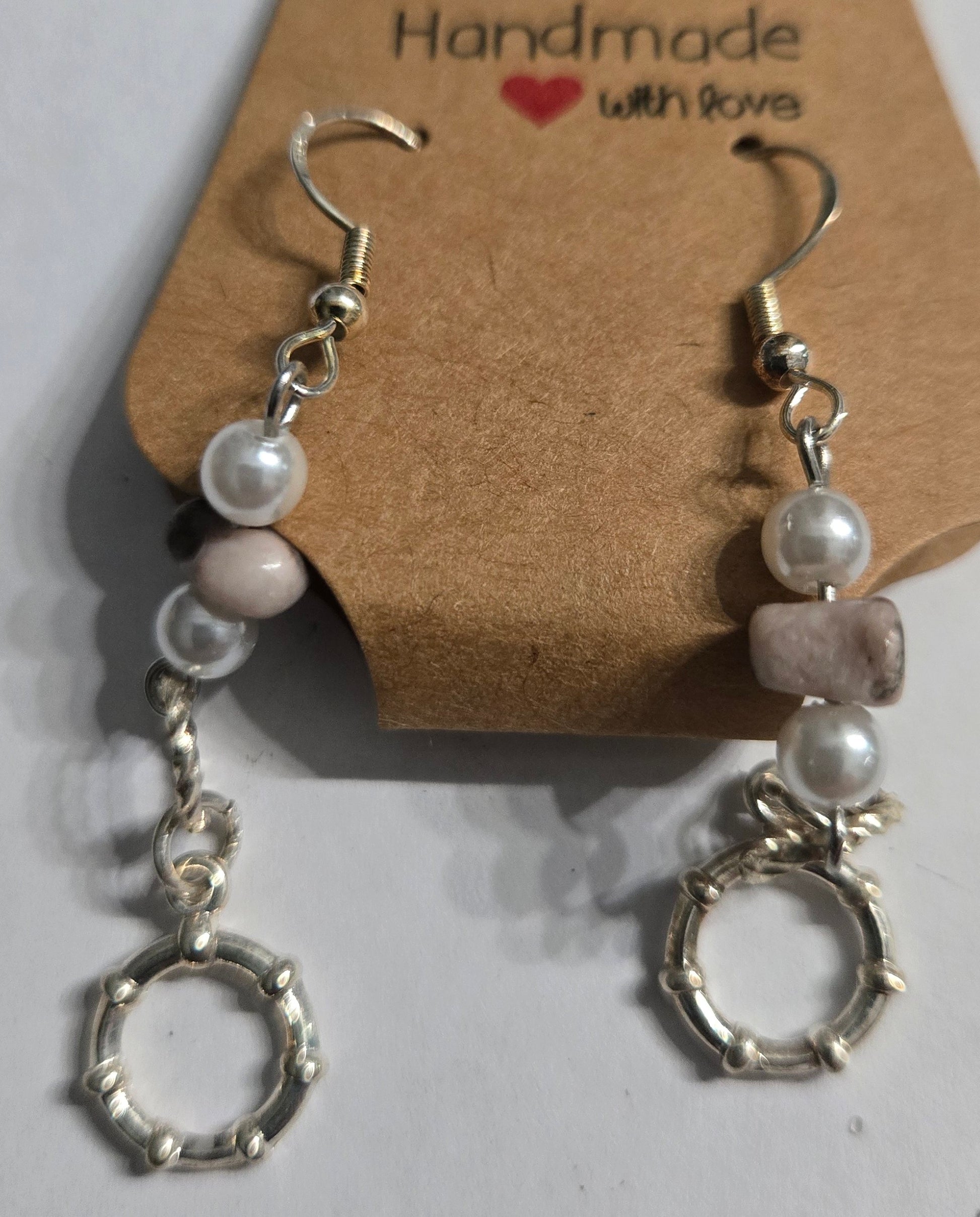 Sterling silver earrings with faux pearl and stone beads, accented with silver metallic hoop charms.