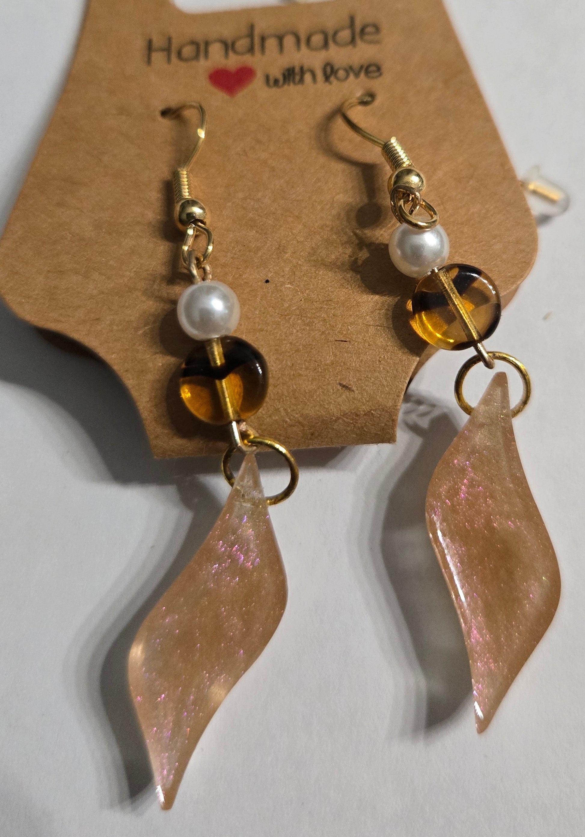 Gold plated earrings with round amber and faux pearl beads, accented with epoxy resin charms.