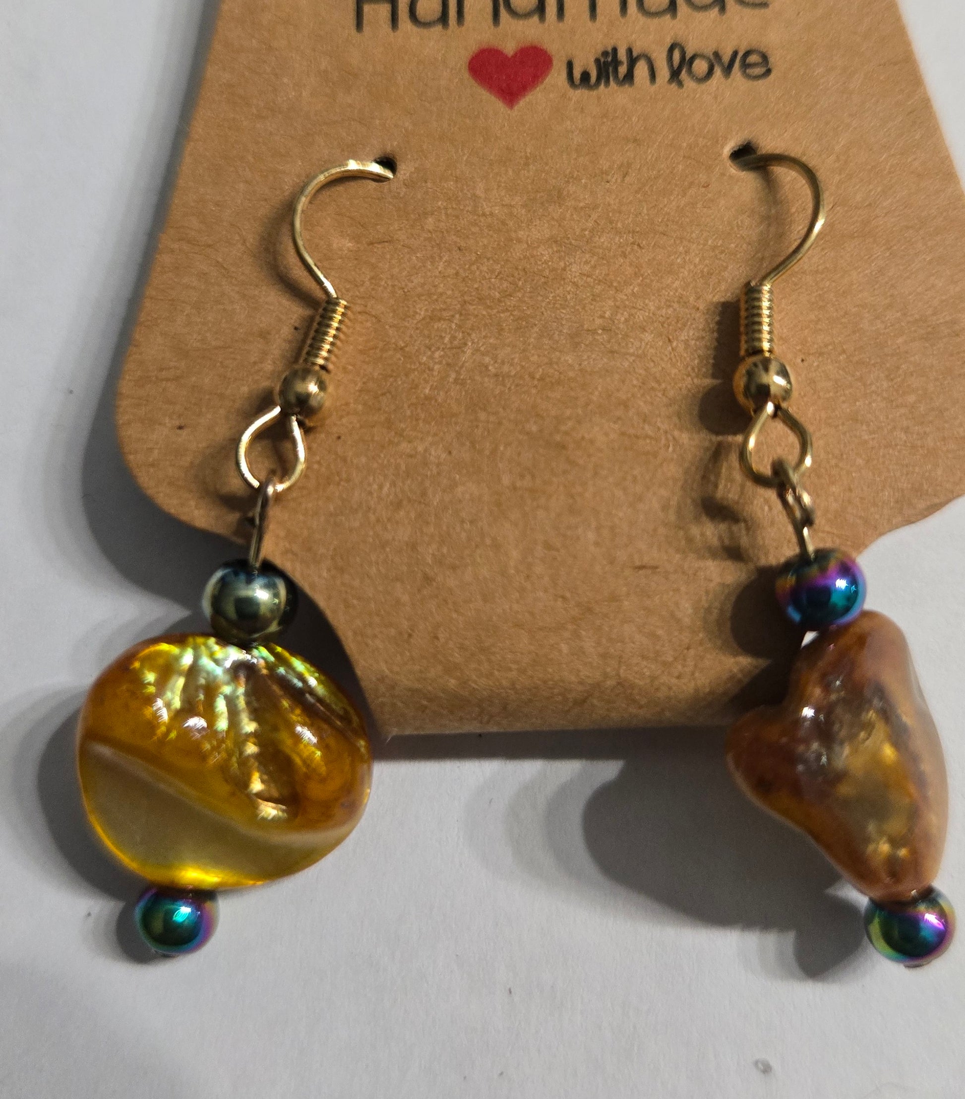 Gold plated earrings with round amber stone beads, accented with holographic beads.