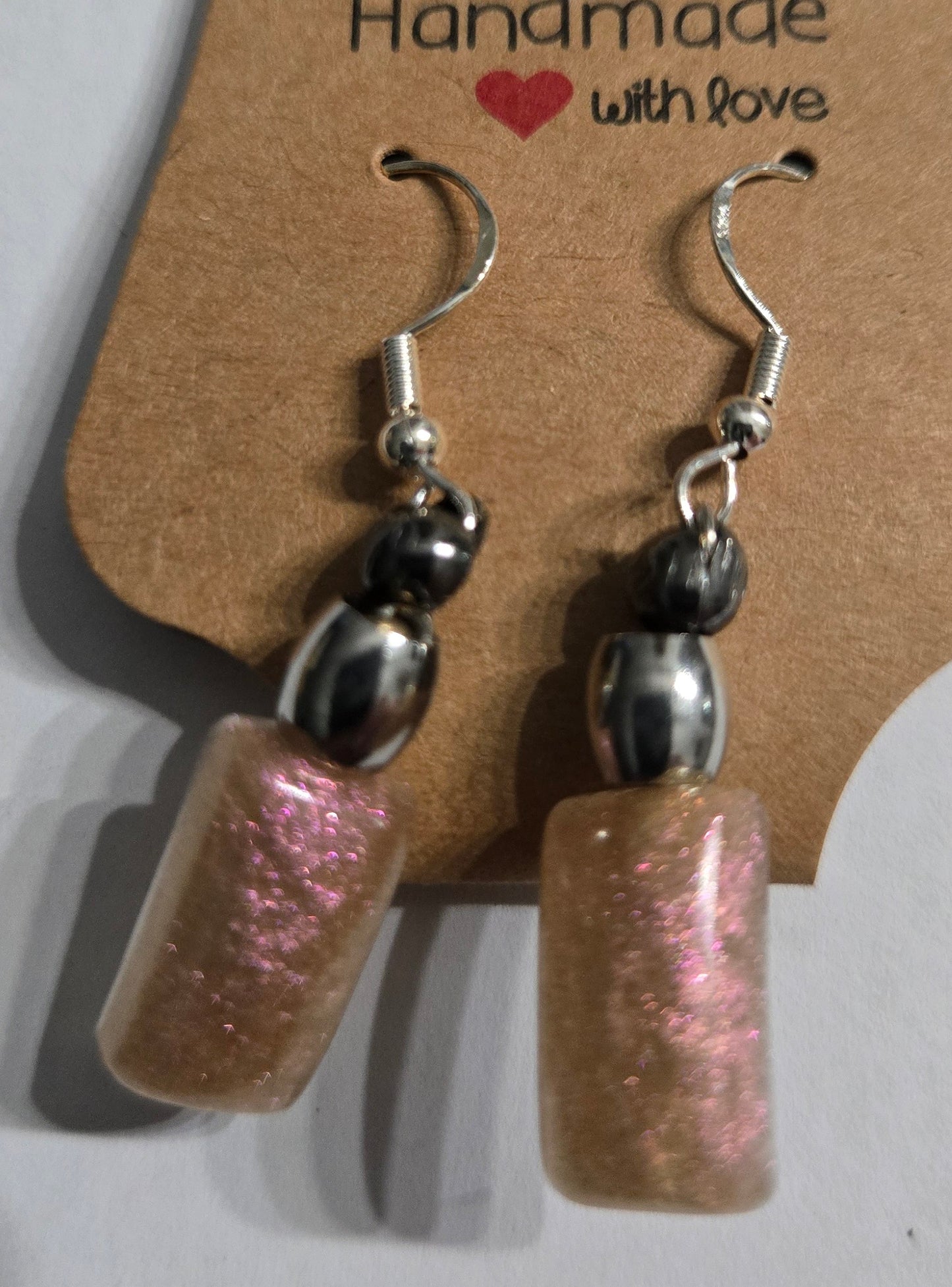 Sterling silver earrings with silver metallic beads, accented with epoxy resin charms.