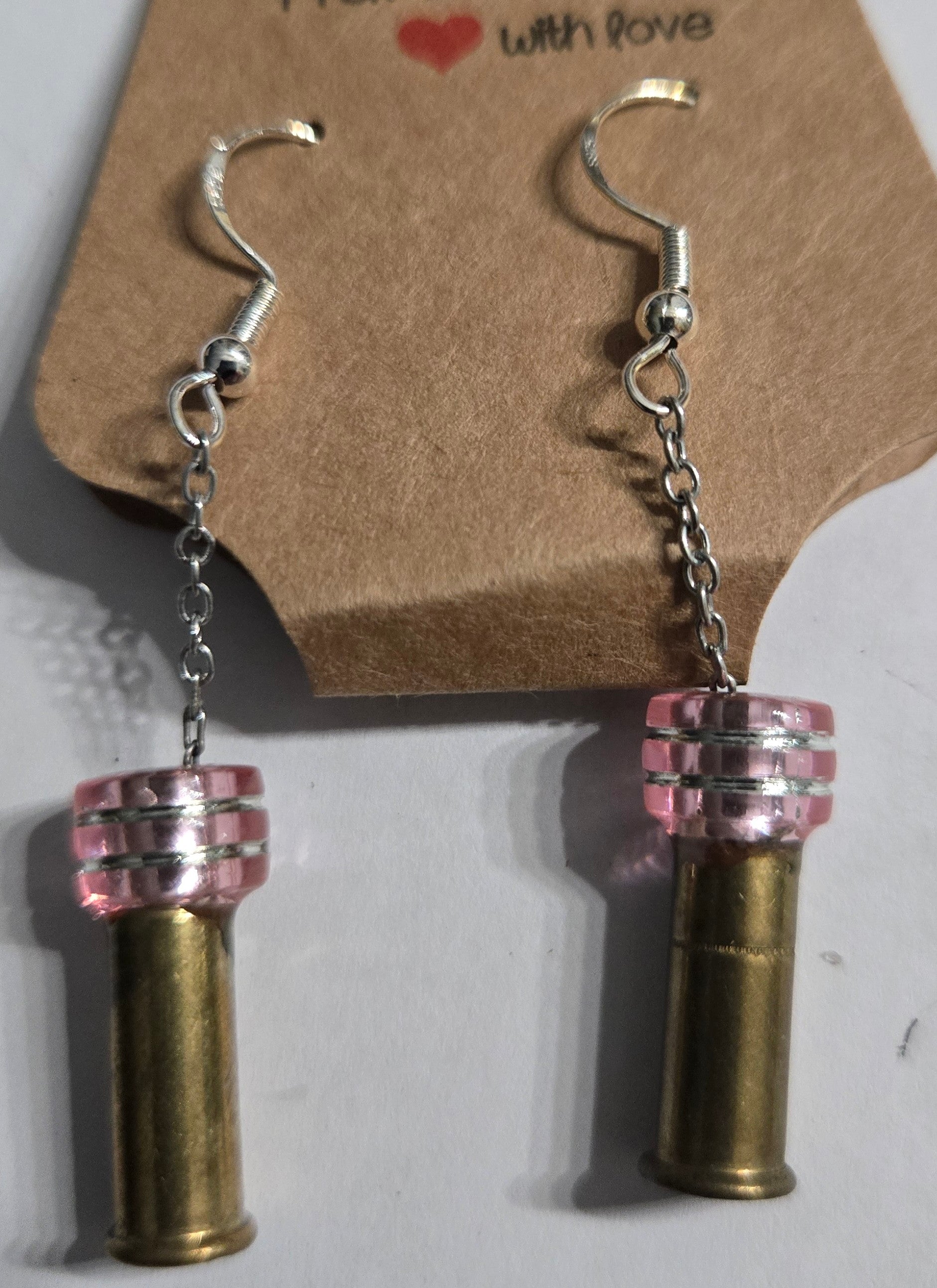 Sterling silver earrings with round pink beads, accented with .22 caliber shell casing charms.