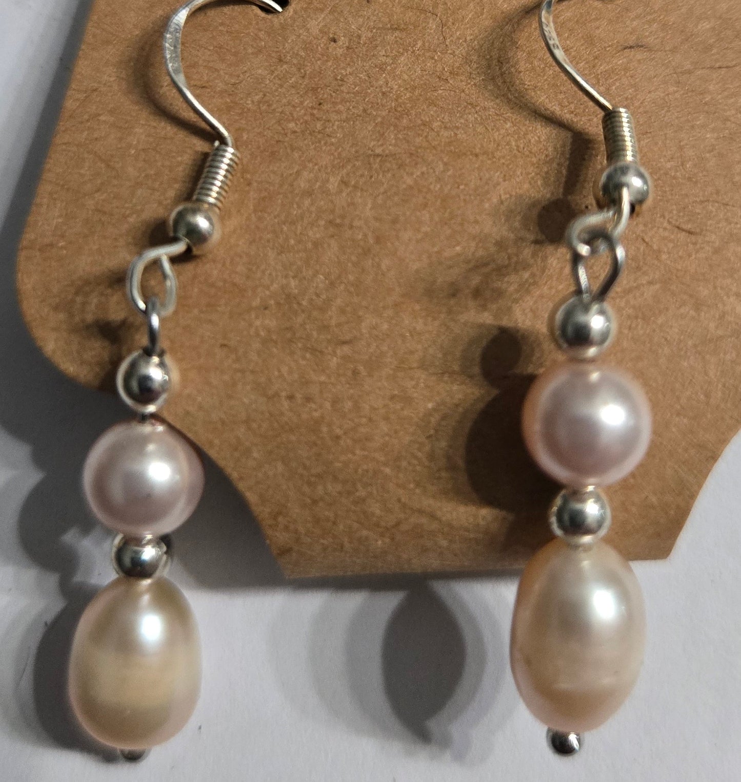 Sterling silver earrings with imitation pearl beads.