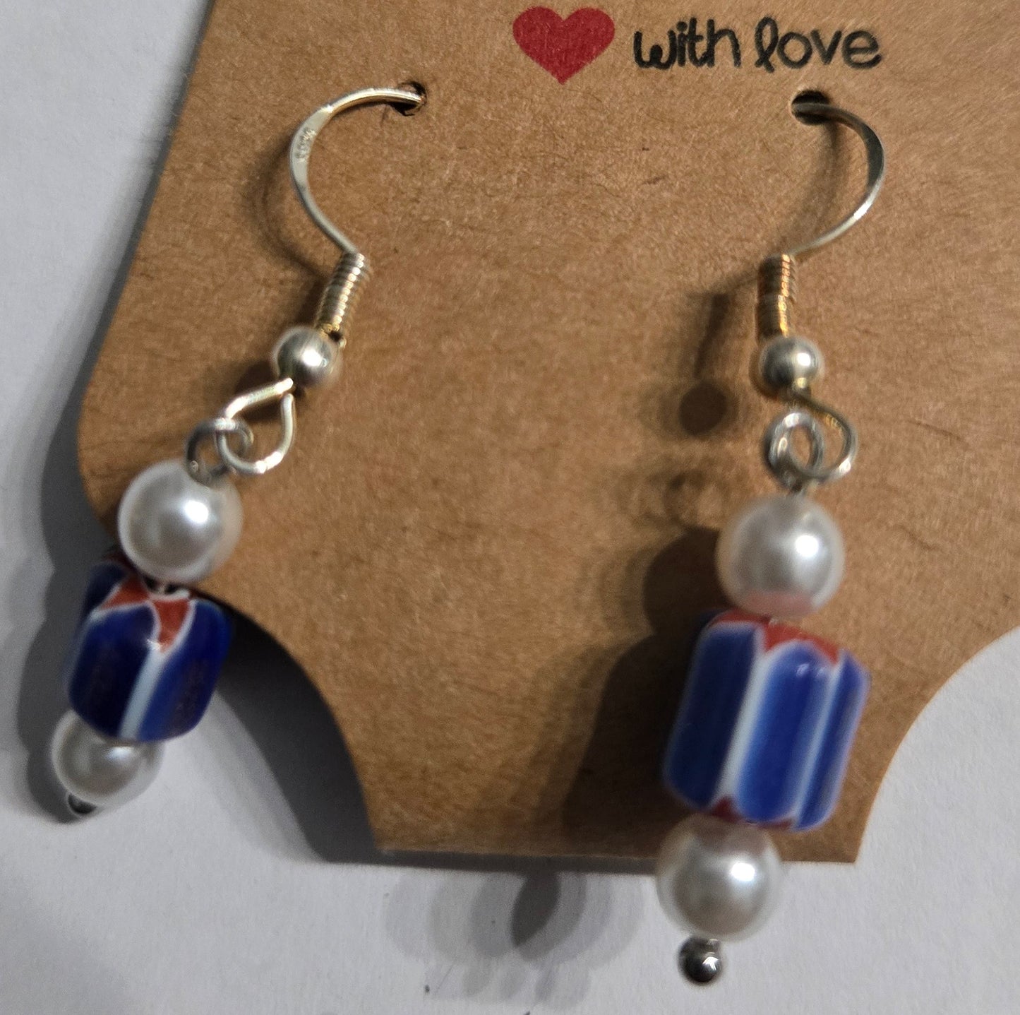 Sterling silver earrings with round faux pearl beads, accented with patriotic charms.