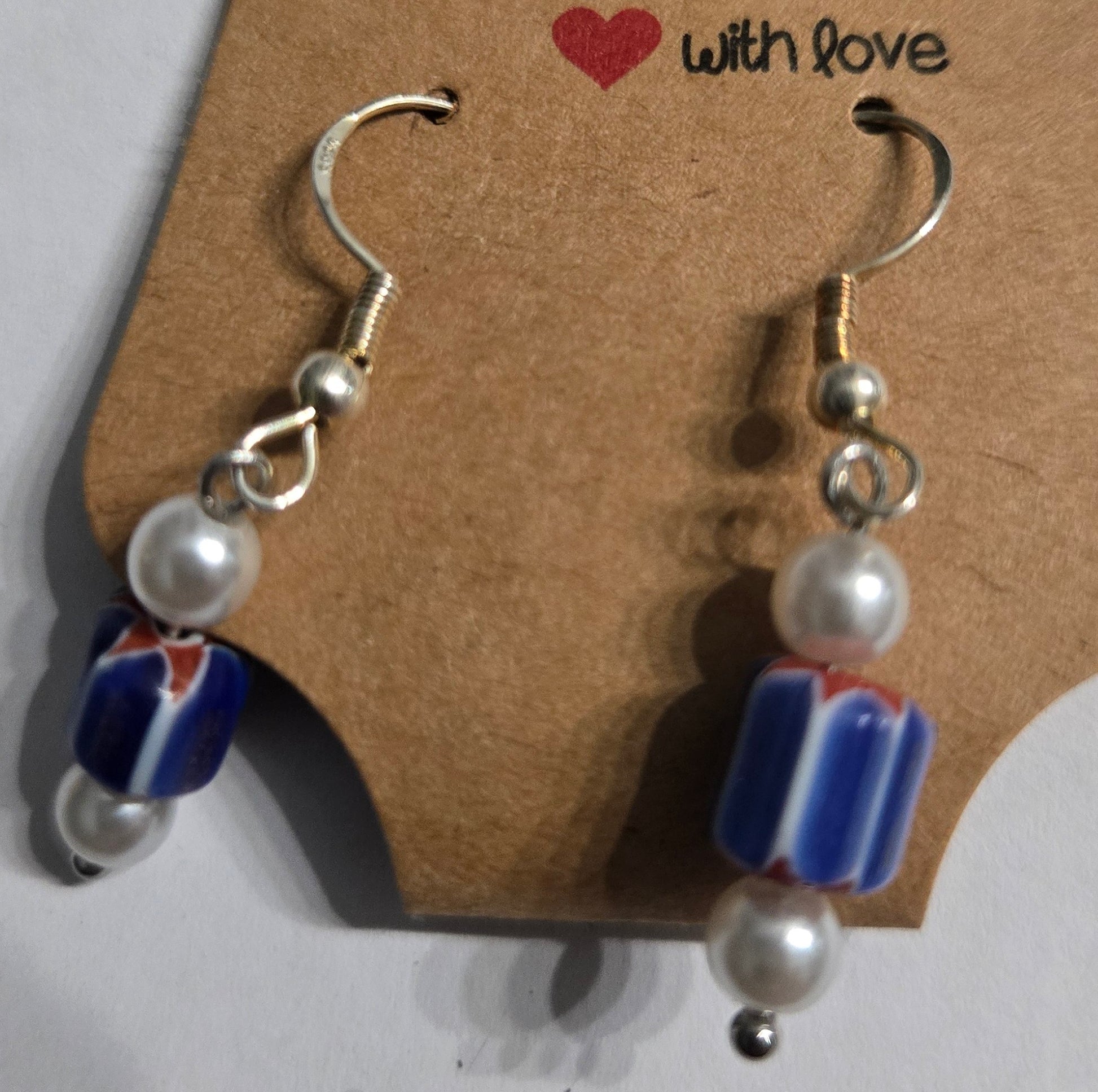 Sterling silver earrings with round faux pearl beads, accented with patriotic charms.