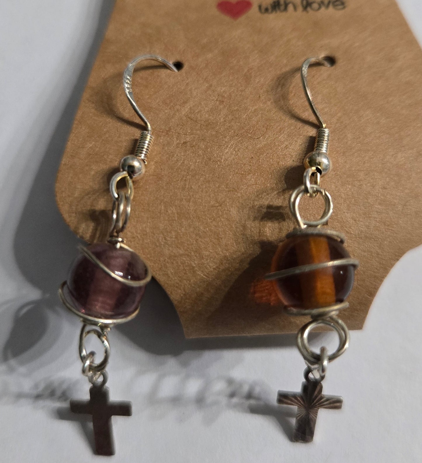 Sterling silver earrings with round amber beads, accented with silver metallic cross charms.