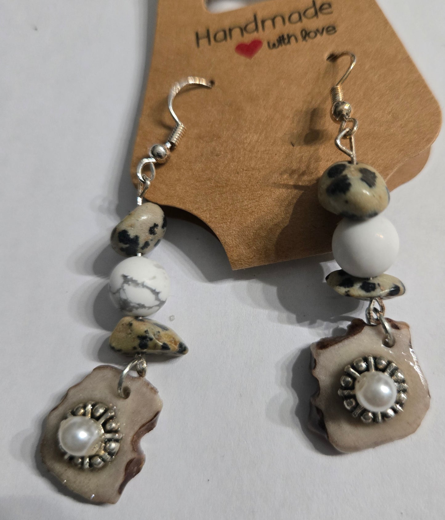 Sterling silver earrings with round white glass beads, "dalmatian jasper" stone beads, and deer antler w/ faux pearl charms.