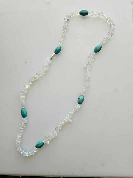 Handmade beaded necklace with clear glass beads with turquoise accent beads.