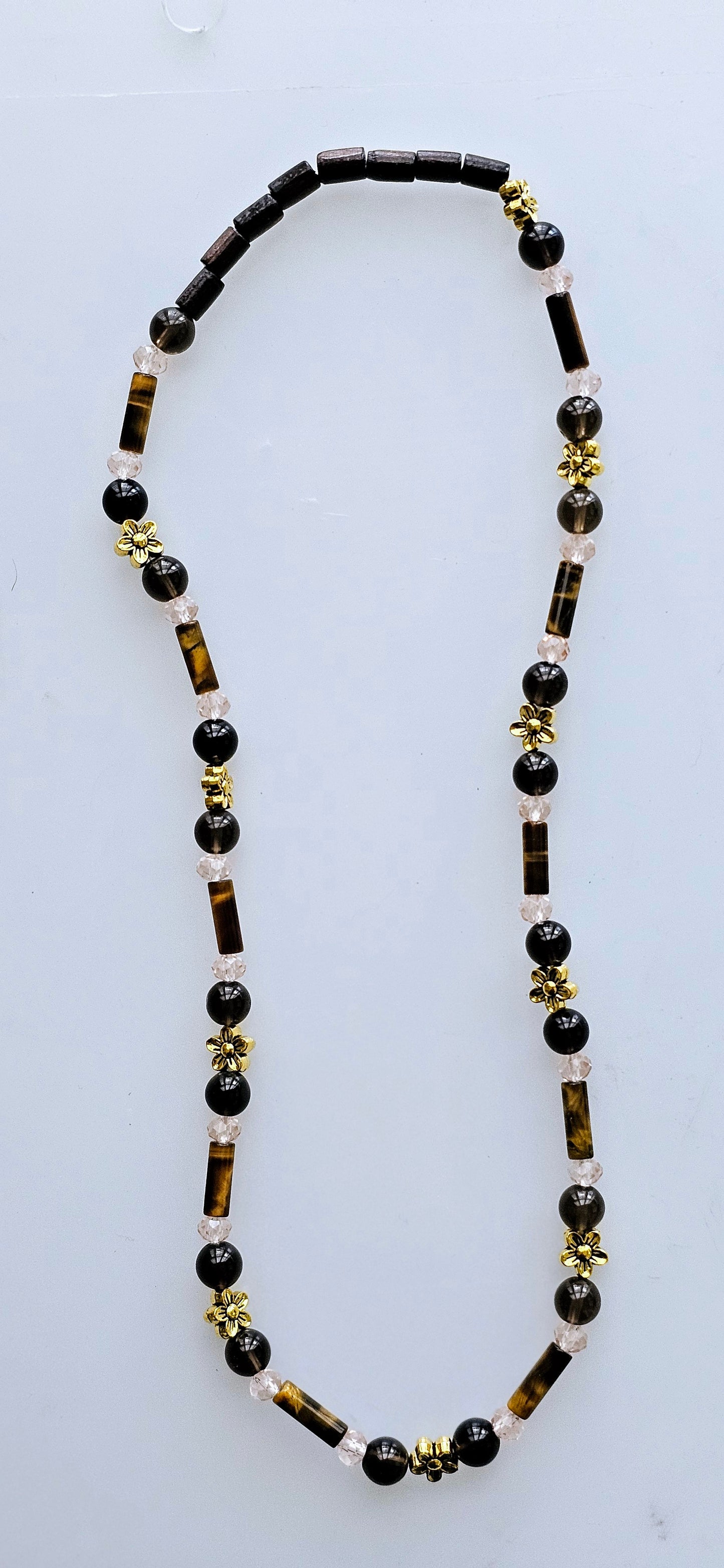 Handmade beaded necklace with genuine Tiger's Eye stone charms, accented with assorted wooden and glass beads, and gold colored charms.