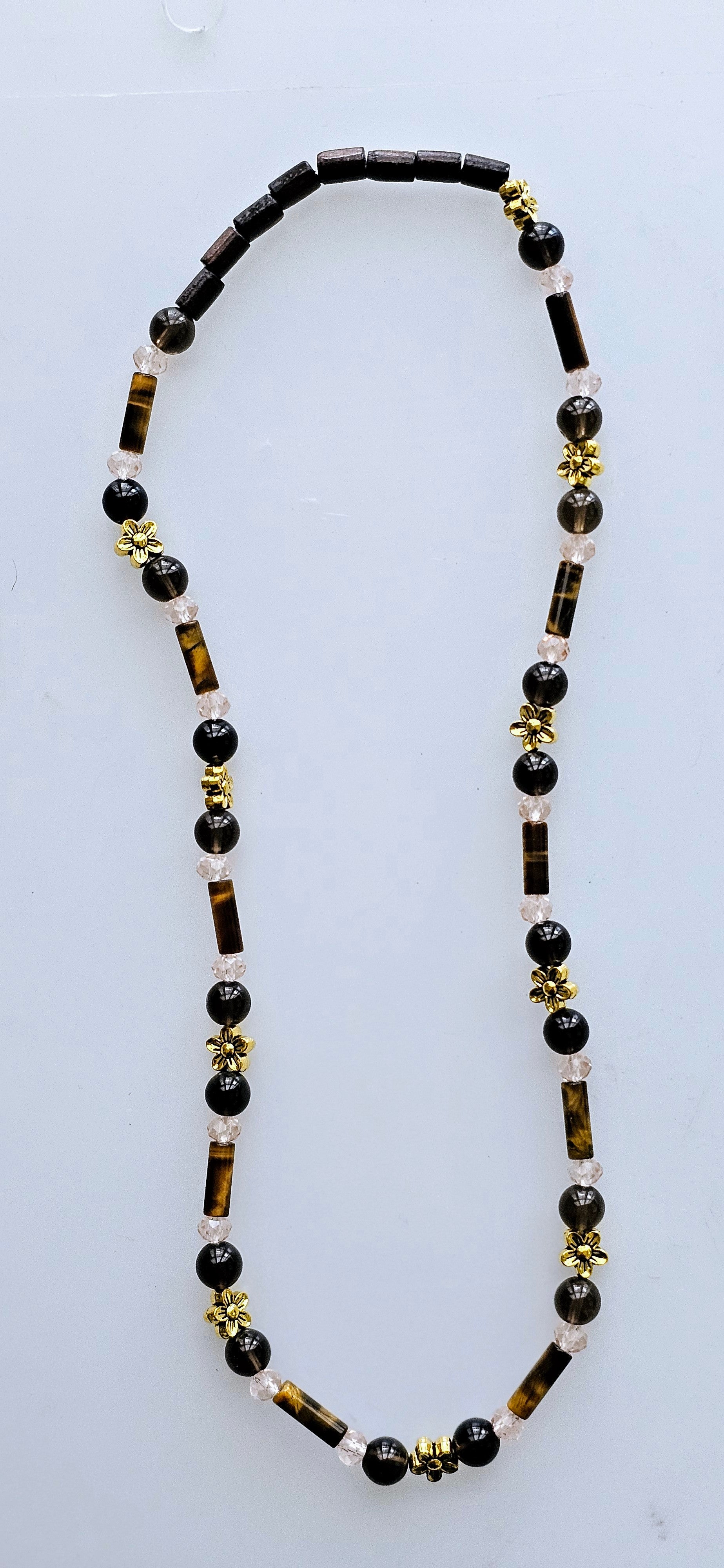 Handmade beaded necklace with genuine Tiger's Eye stone charms, accented with assorted wooden and glass beads, and gold colored charms.