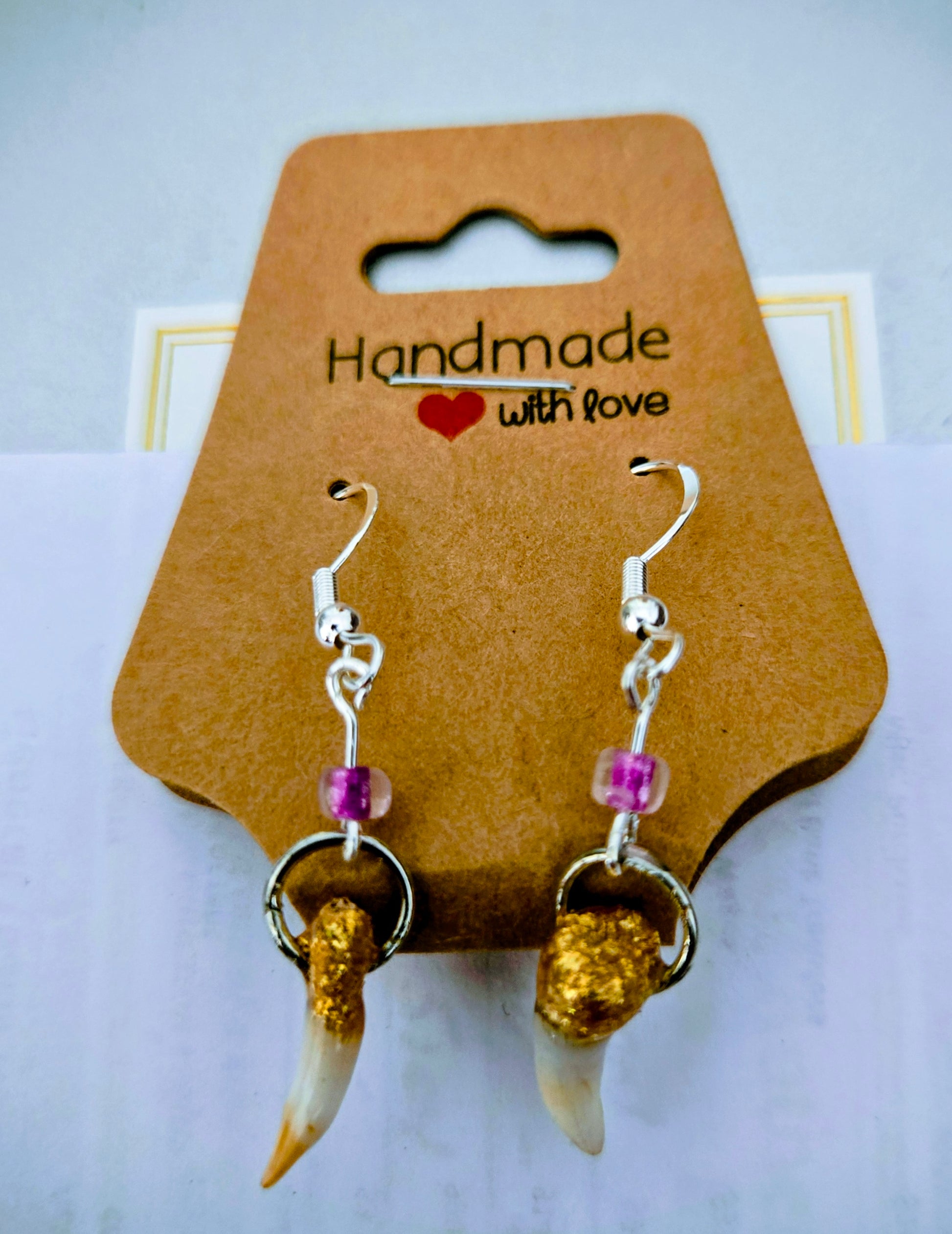 Genuine Alligator Teeth earrings mounted on sterling silver earring facets, with purple accent beads.